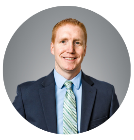 Picture of a man wearing a suit standing and smiling