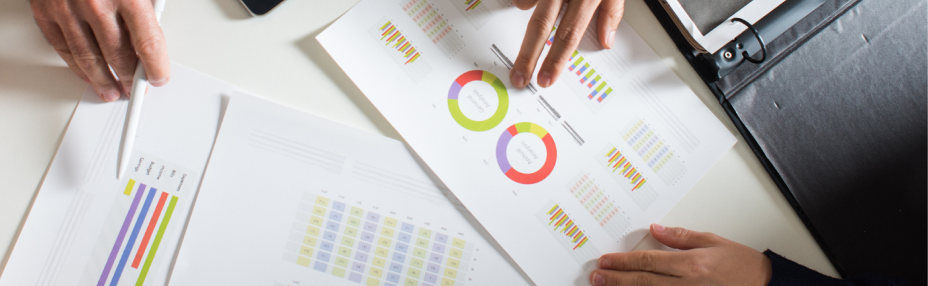 looking over graphs and charts on paper
