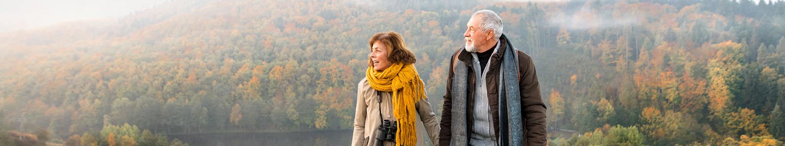 Mature couple walking outside in the fall.