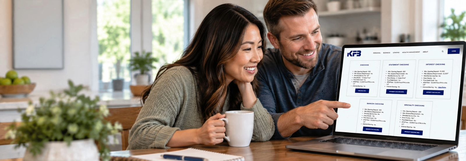 Couple looking at KFB Checking accounts online